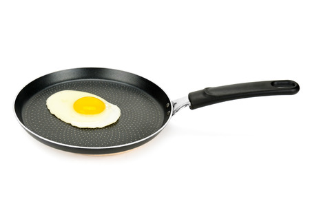 pan with fried eggs isolated on white backgroundの写真素材