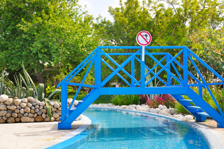 footbridge over the pool in the summer parkの写真素材