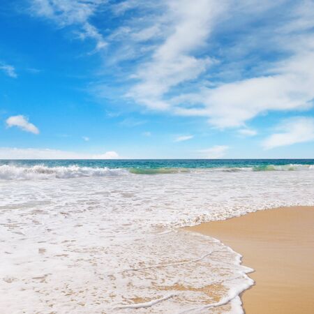 ocean, sandy beach and blue skyの写真素材