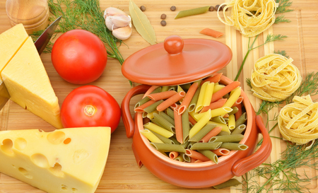 pasta, cheese and spices on the boardの写真素材