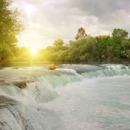 waterfall on the river in the mountainsの写真素材