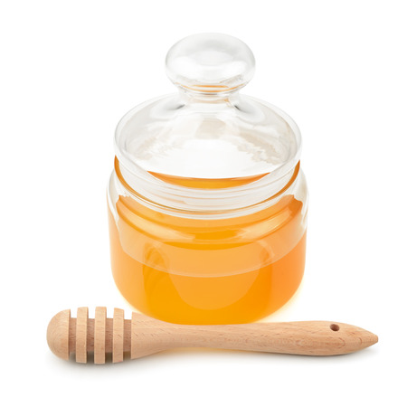 pot with honey and drizzler isolation on a white backgroundの写真素材