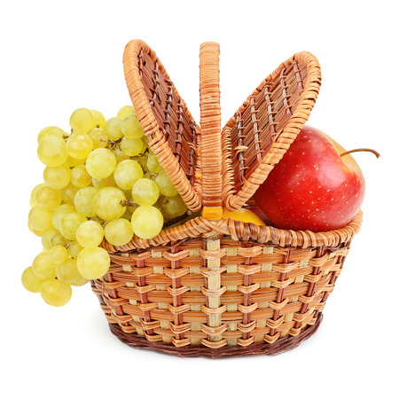 grapes and apples in the basket isolated on a white backgroundの写真素材