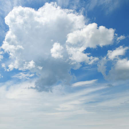 The white cumulus clouds against the blue skyの写真素材