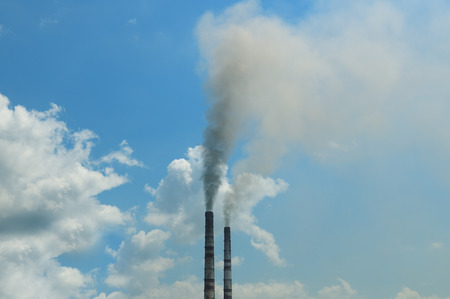 smoke from the pipes against the blue skyの写真素材