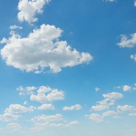 white cumulus clouds against the blue skyの写真素材