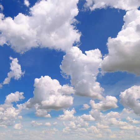 white cumulus clouds against the blue skyの写真素材