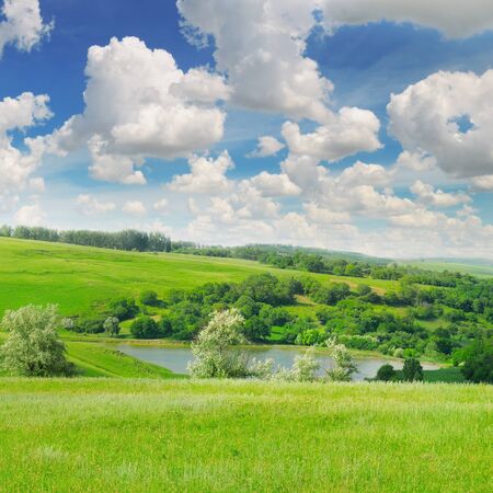 picturesque green field and blue skyの写真素材