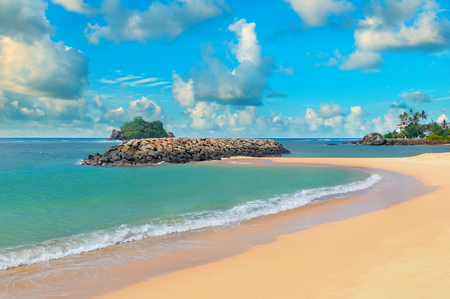 ocean, sandy beach and blue skyの写真素材