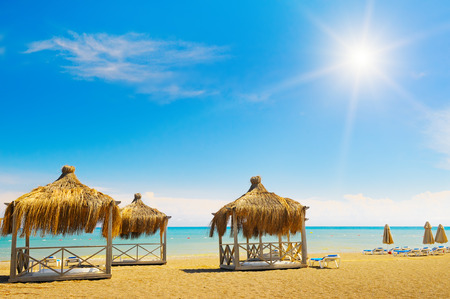 sandy beach, awnings and sunbedsの写真素材