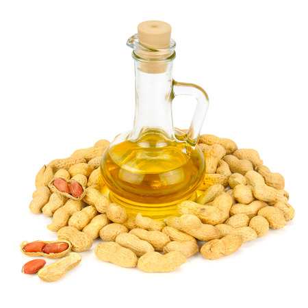 peanuts and oil in bottle isolated on white backgroundの写真素材