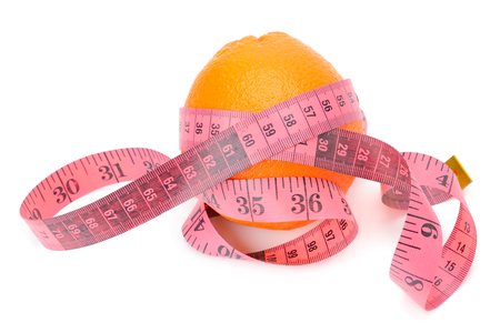 Orange and measuring tape isolated on white backgroundの写真素材