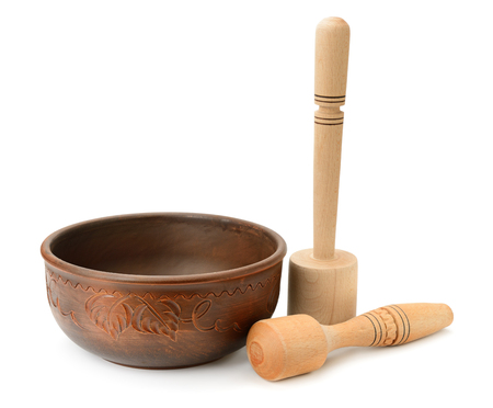 earthenware dish and wooden pestle isolated on white backgroundの写真素材