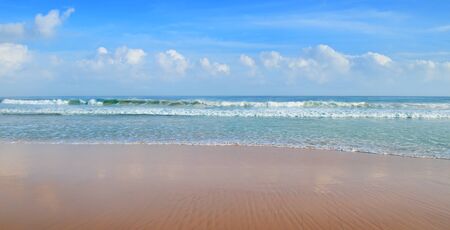 ocean, sandy beach and blue skyの写真素材