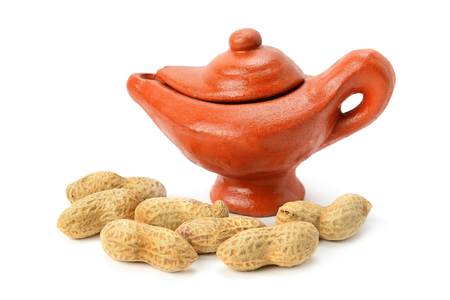 Peanuts and clay amphora isolated on white backgroundの写真素材