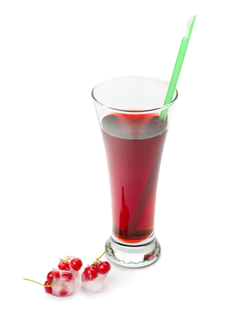 Berry juice in a glass and currant in ice isolated on white backgroundの写真素材