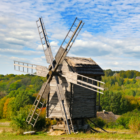 old wooden windmill in field and skyの写真素材