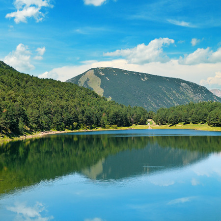 picturesque lake, mountains and blue skyの写真素材