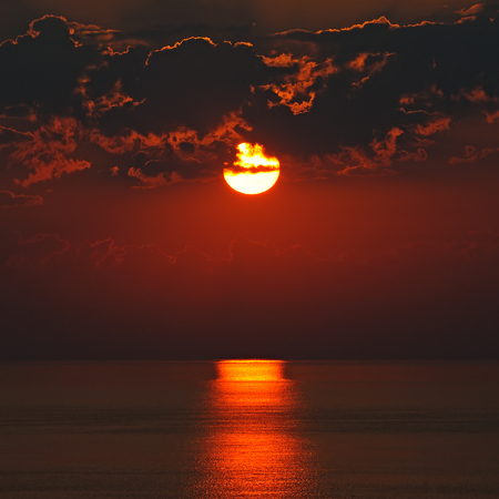 Bright sun rise over the oceanの写真素材