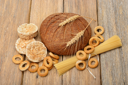 bread, pasta and pastries on a wooden backgroundの写真素材