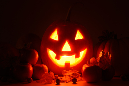 scary pumpkin head with glowing eyes - a symbol of Halloweenの写真素材