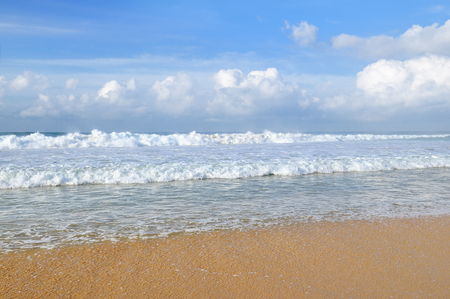 ocean, sandy beach and blue skyの写真素材