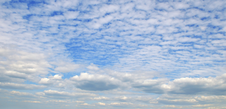 Light cumulus clouds in the blue sky. Wide image.の写真素材