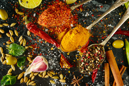Variety of spices and herbs on kitchen table.の写真素材