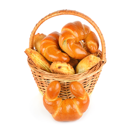 Croissants and cottage cheese rolls in wicker basket isolated on white background.の写真素材