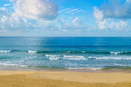 Deserted sandy beach of the Indian Ocean. In the blue sky, picturesque cumulus clouds.の写真素材