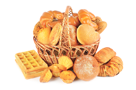 Sweet pastries, bread and flour products in a wicker basket isolated on white background.の写真素材