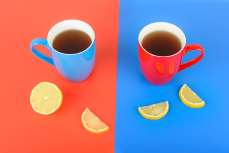 Red and blue cups with tea on a red and blue background. Flat lay,top view. Free space for text.の写真素材