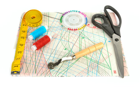 Sewing accessories and paper pattern isolated on white background. Flat lay, top view.