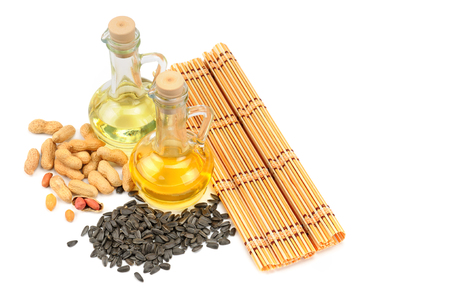Peanuts, sunflower seeds and vegetable oils isolated on white background. Free space for text.の写真素材