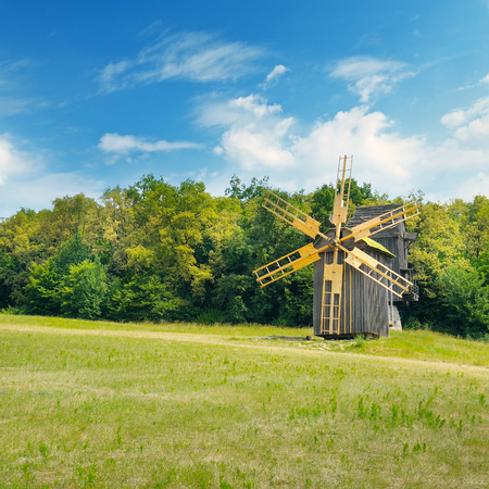 Old wooden windmill in a field and sky.Agricultural landscape.の写真素材