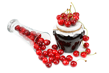 Cherries and jars of jam isolated on a white backgroundの写真素材