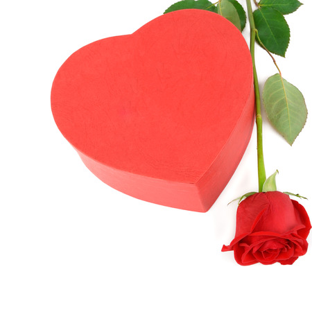 Gift box in the form of heart and scarlet rose isolated on white background. Free space for text. Flat lay, top view.の写真素材
