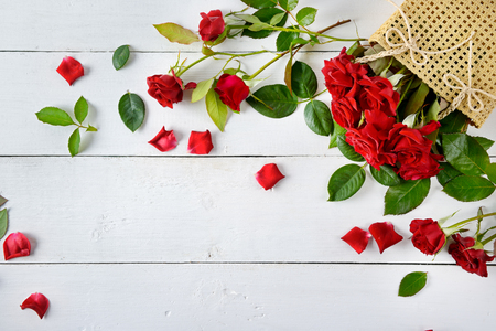 Flowers composition. Red roses on a white wooden background. Free space for text. Flat lay, top view.の写真素材