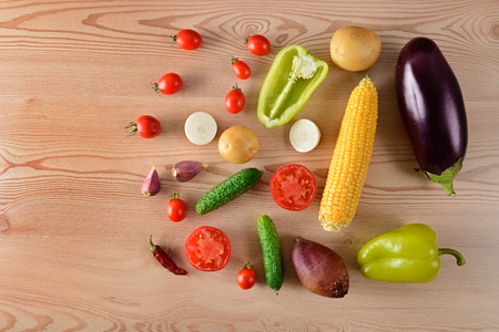 A set of vegetables laid out on a wooden table. Flat lay,top view. Free space for text.の写真素材