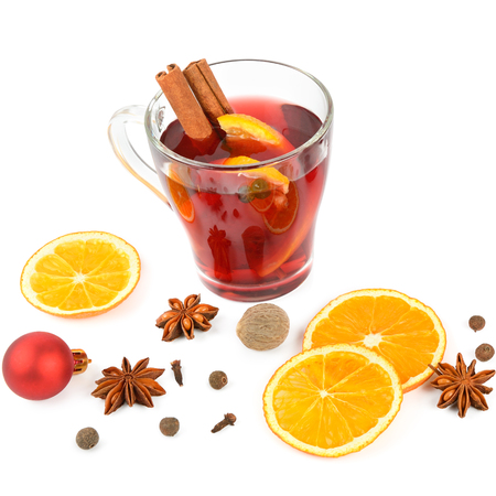 Hot red mulled wine isolated on white background with spices, orange slice, anise and cinnamon sticks, close up. Flat lay, top view.の写真素材