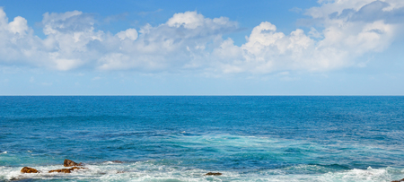 Tropical ocean, beach, high waves and blue sky. Wide photo.の写真素材