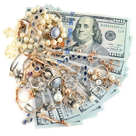 Gold jewelry and dollars isolated on white background.Flat lay, top view.の写真素材