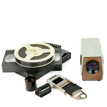 Old videocassettes and video projector with slides isolated on white background. Free space for text.の写真素材