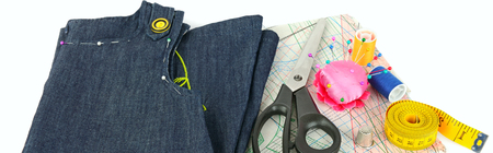 Sewing accessories and paper pattern isolated on white background. Flat lay, top view. Wide photo.の写真素材