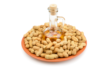 Peanuts and vegetable oils isolated on white background. Healthy food.の写真素材