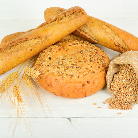 Fresh bread and wheat on the wooden table. Healthy food.の写真素材