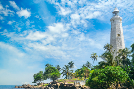 Beautiful lighthouse, lagoon and tropical palms (Matara Sri Lanka).の写真素材