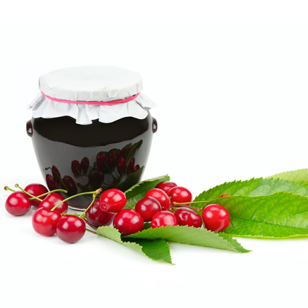 Cherries and jars of jam isolated on a white background. Free space for text.の写真素材