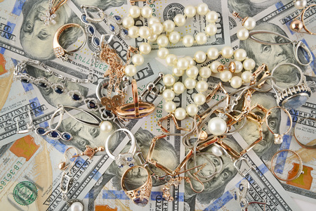 Background of American dollars and jewelry. Flat lay, top view.の写真素材