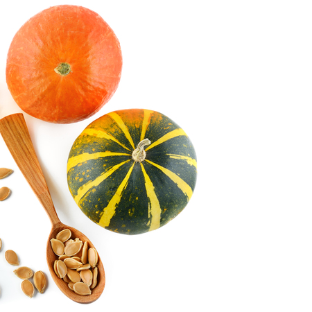 Seeds and pumpkin fruits isolated on white background. Flat lay, top view. Free space for text.の写真素材